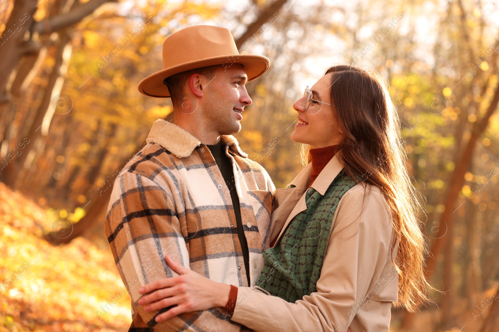 Photo of Happy couple spending time together in autumn park