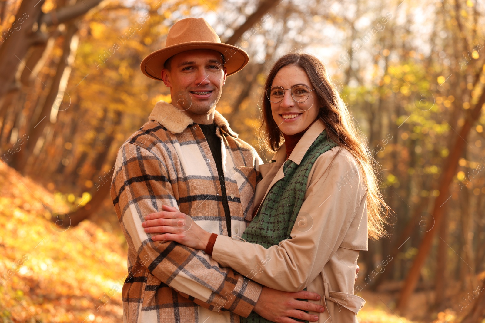 Photo of Happy couple spending time together in autumn park