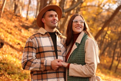 Photo of Happy couple spending time together in autumn park