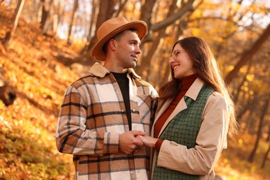 Photo of Happy couple spending time together in autumn park