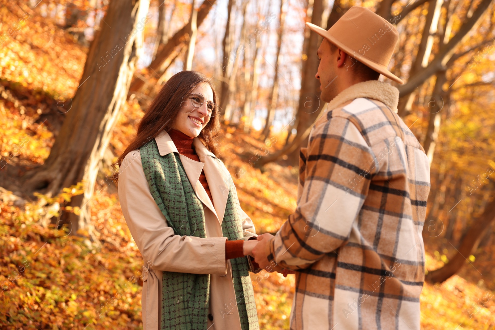 Photo of Happy couple spending time together in autumn park