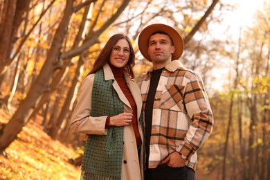 Happy couple spending time together in autumn park