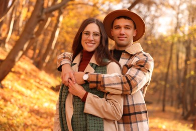 Photo of Happy couple spending time together in autumn park