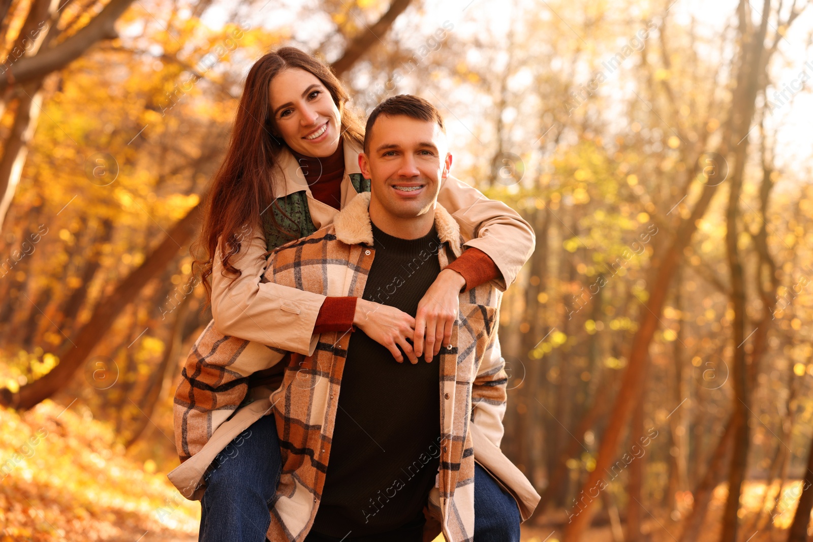 Photo of Happy couple spending time together in autumn park