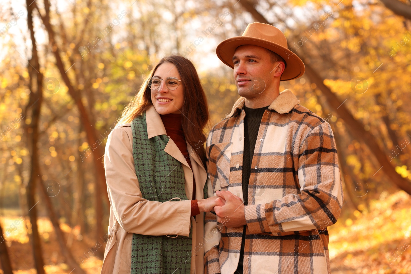 Photo of Happy couple spending time together in autumn park