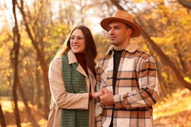 Happy couple spending time together in autumn park