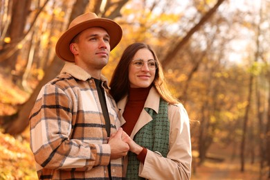 Photo of Happy couple spending time together in autumn park