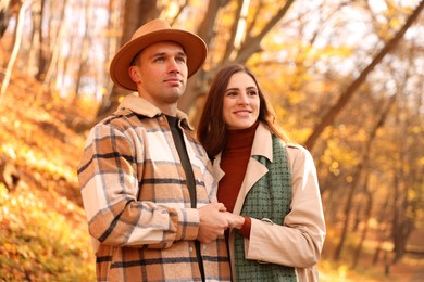 Happy couple spending time together in autumn park