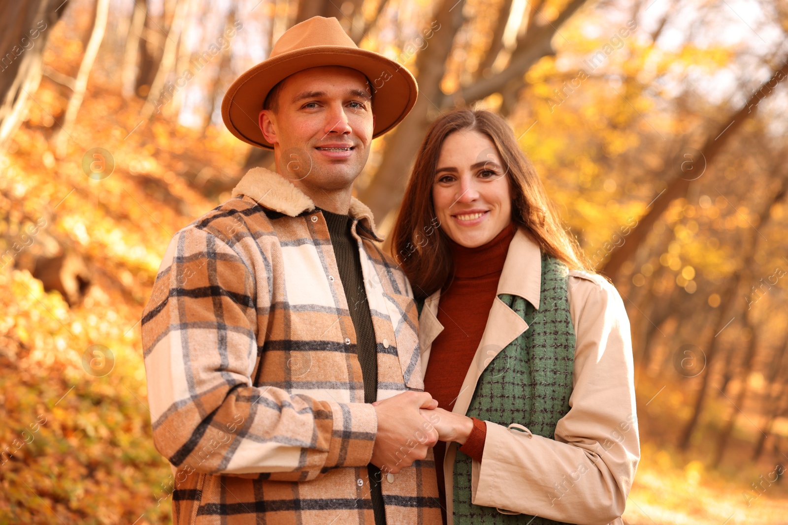 Photo of Happy couple spending time together in autumn park