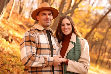 Photo of Happy couple spending time together in autumn park