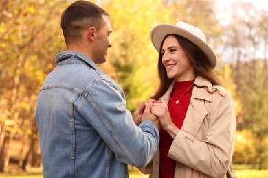 Photo of Happy couple spending time together in autumn park