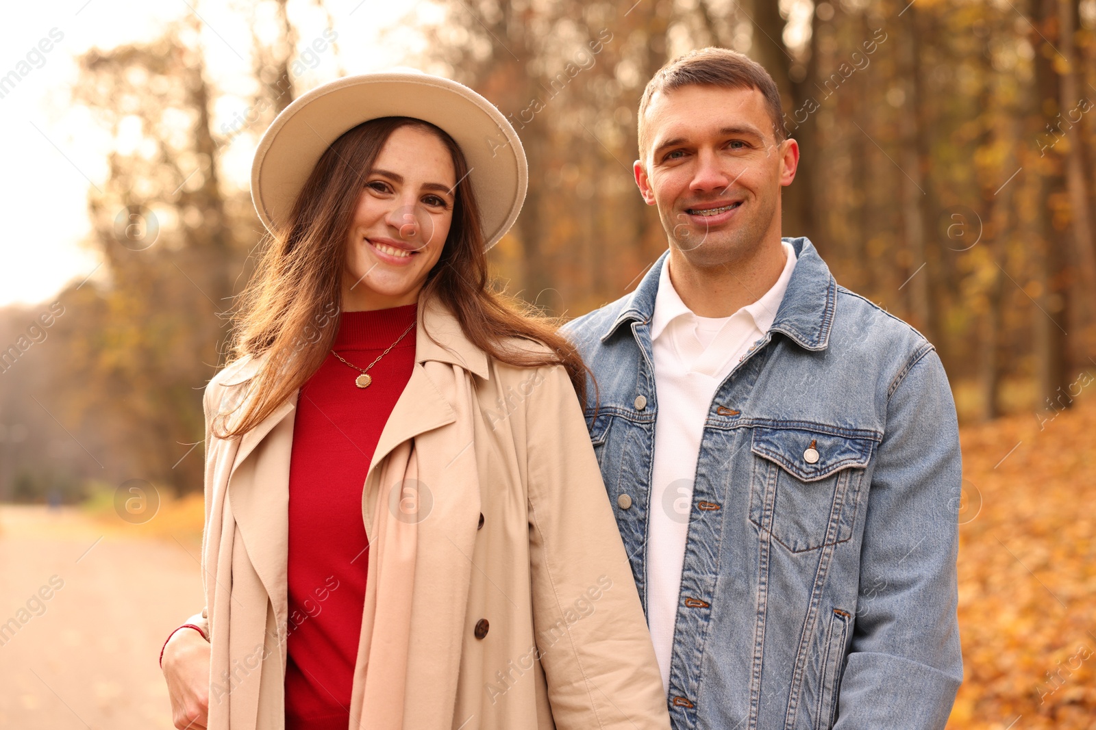 Photo of Happy couple spending time together in autumn park