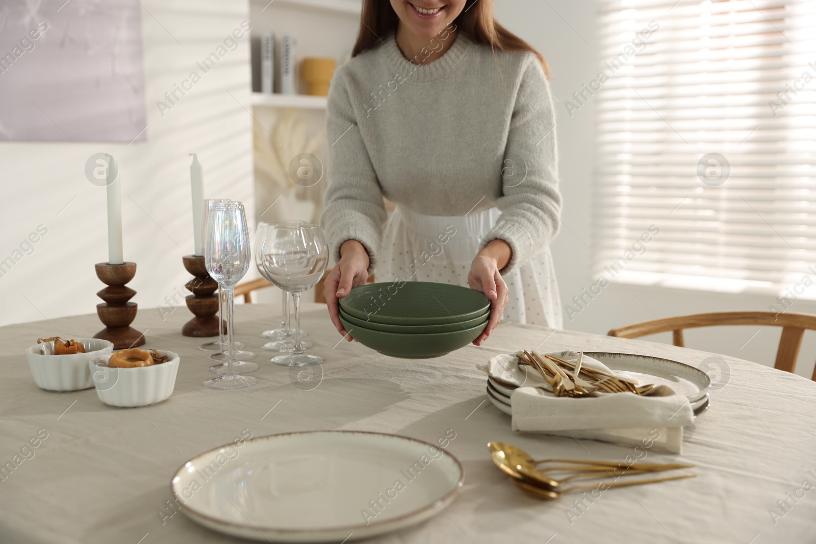 Photo of Woman setting table for dinner at home, closeup