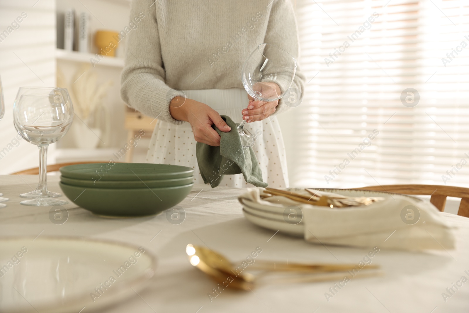 Photo of Woman setting table for dinner at home, closeup