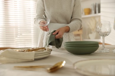 Photo of Woman setting table for dinner at home, closeup