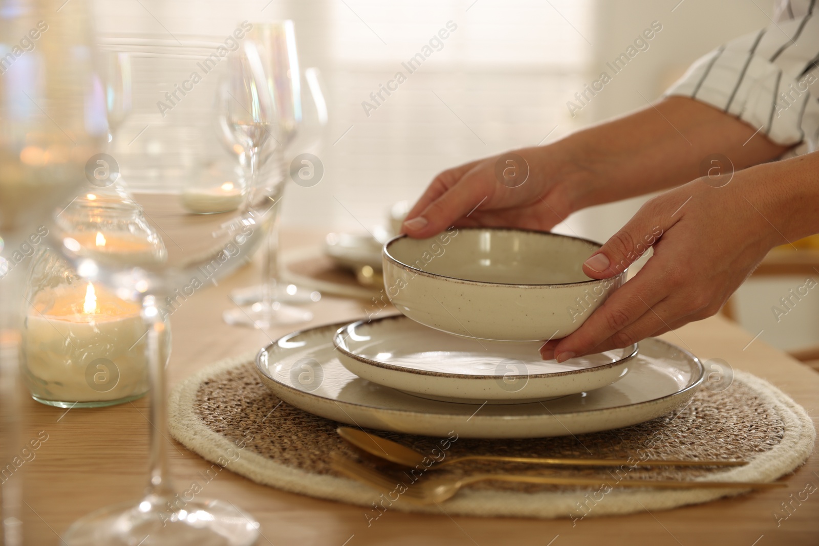 Photo of Woman setting table for dinner at home, closeup