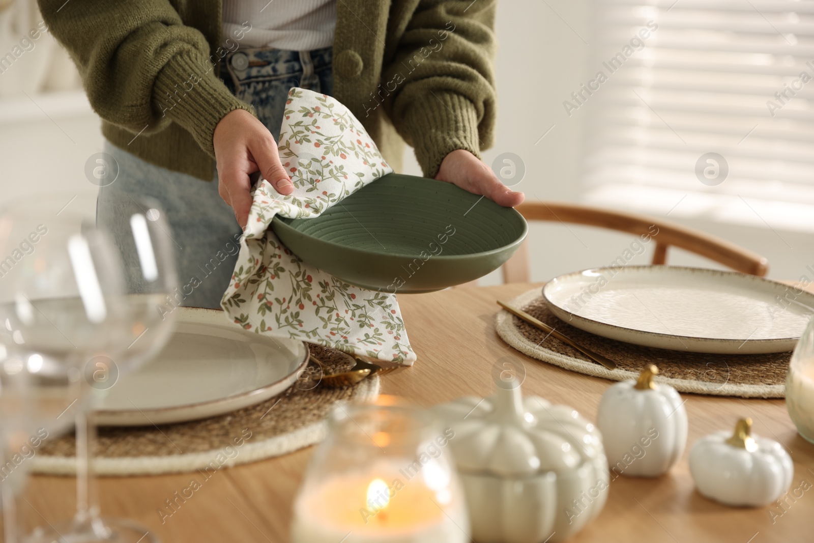 Photo of Woman setting table for dinner at home, closeup