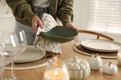 Photo of Woman setting table for dinner at home, closeup