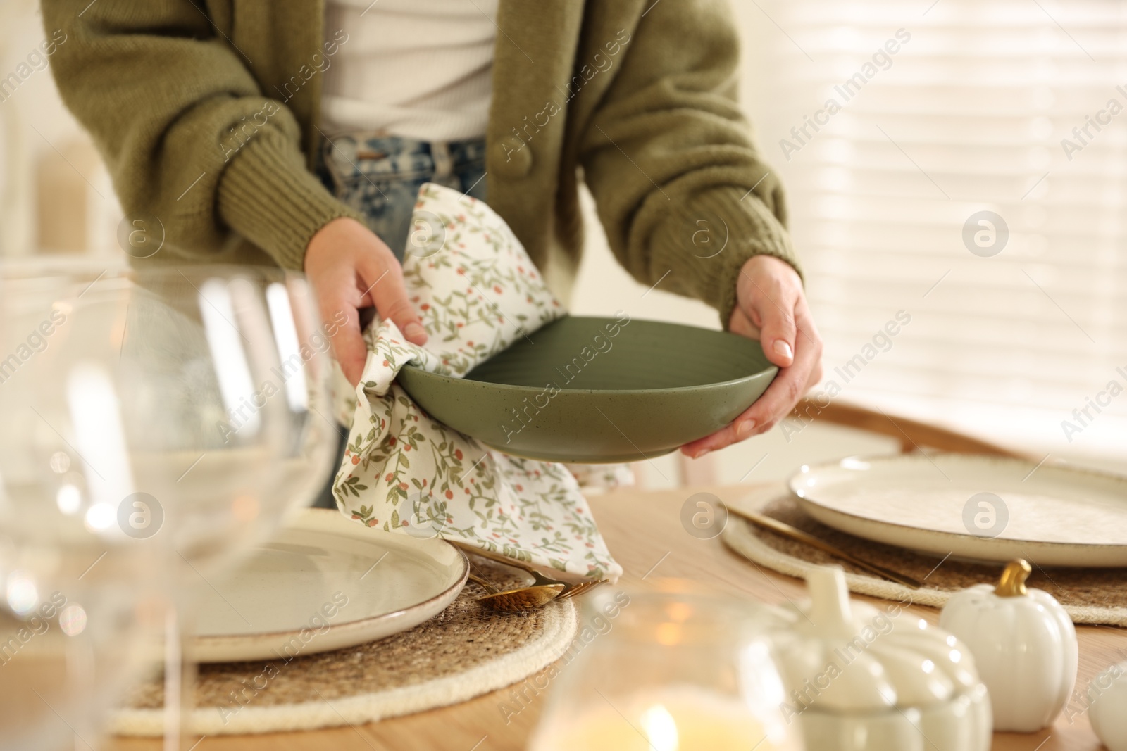 Photo of Woman setting table for dinner at home, closeup