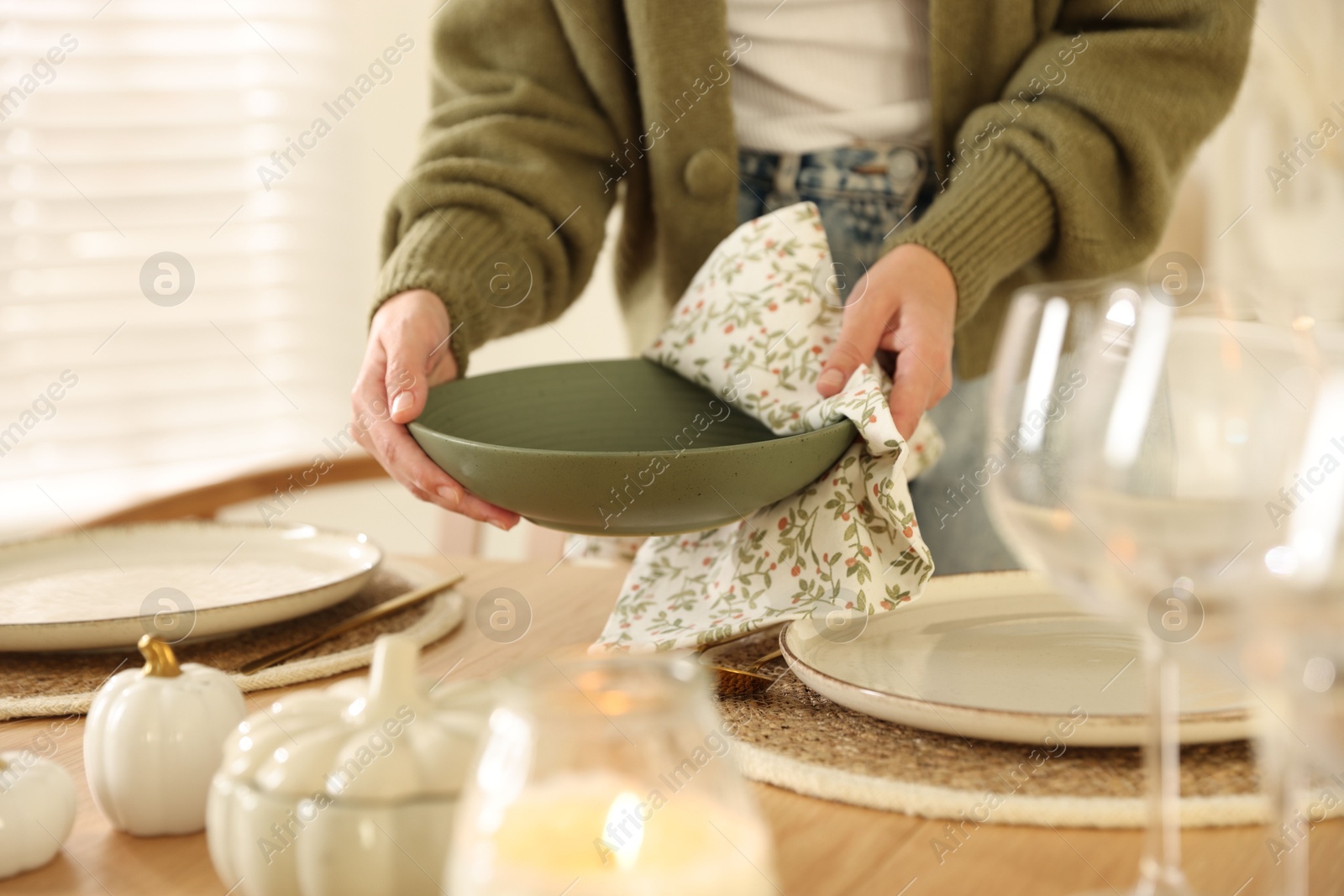 Photo of Woman setting table for dinner at home, closeup