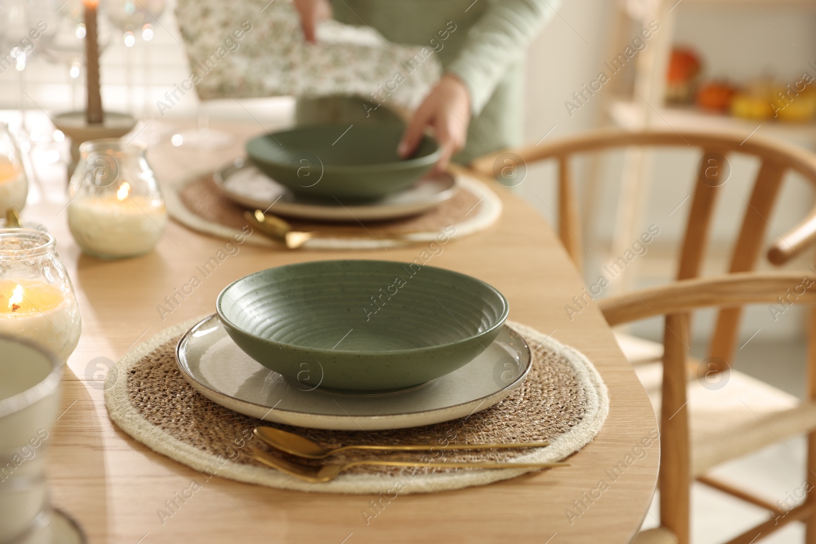 Photo of Woman setting table for dinner at home, closeup