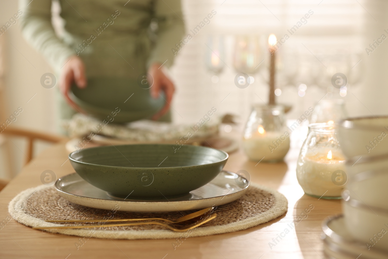 Photo of Woman setting table for dinner at home, closeup