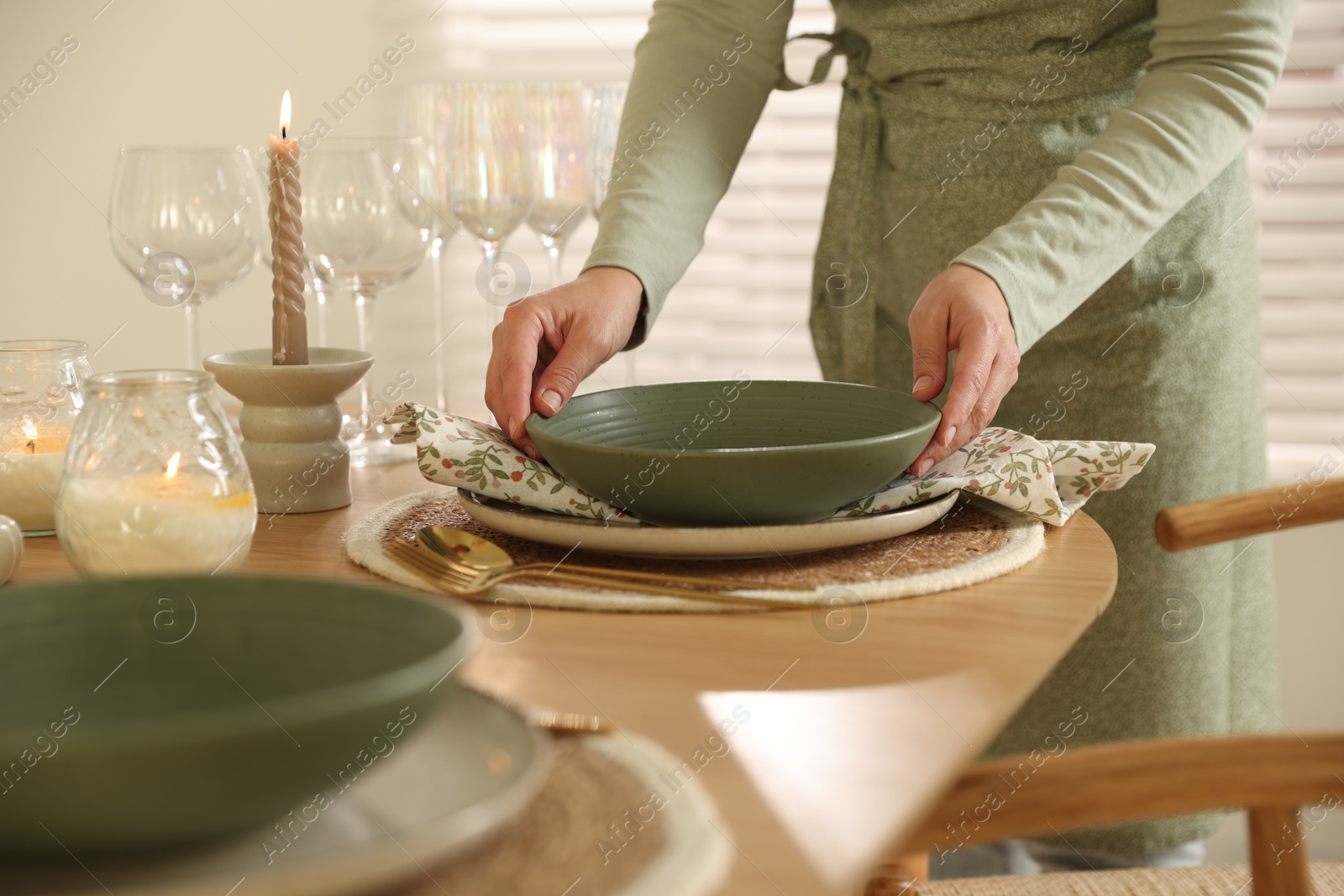 Photo of Woman setting table for dinner at home, closeup