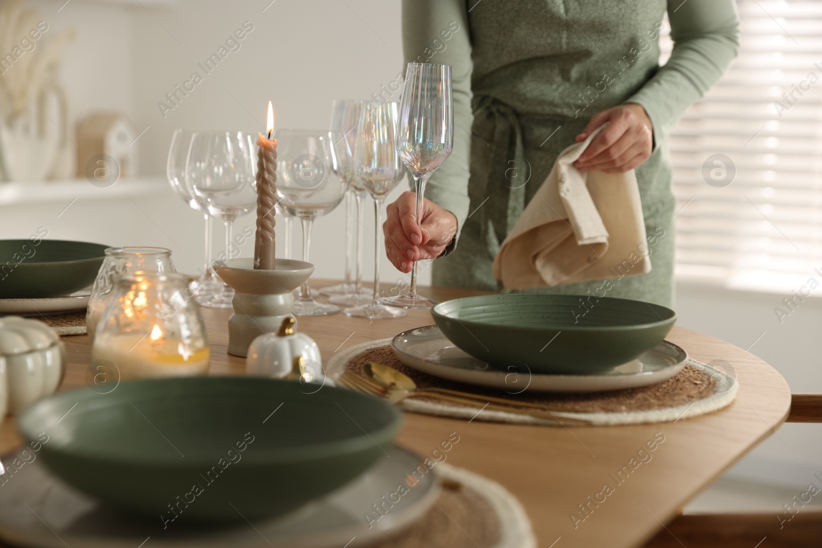 Photo of Woman setting table for dinner at home, closeup