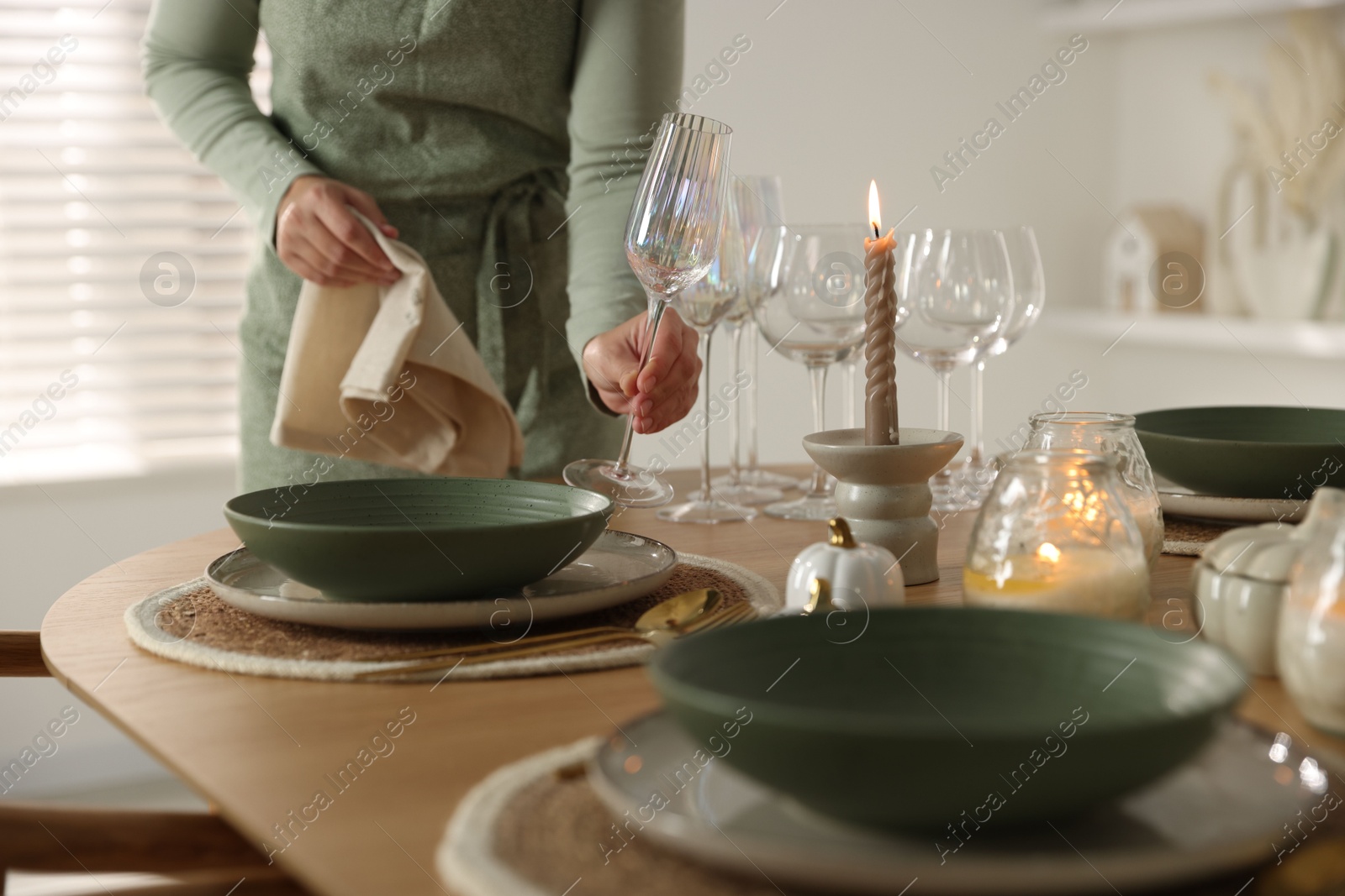 Photo of Woman setting table for dinner at home, closeup