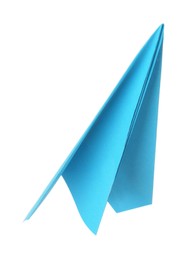 Photo of One handmade light blue paper plane isolated on white