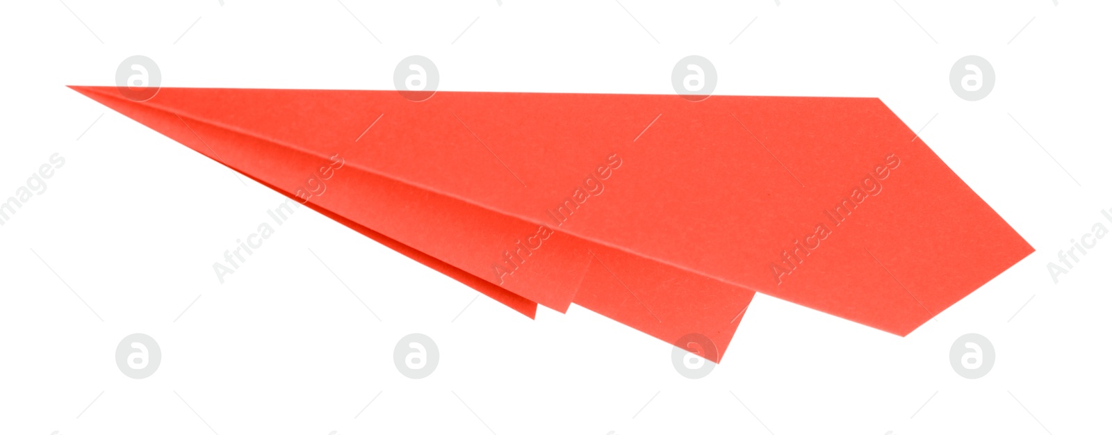 Photo of One handmade coral paper plane isolated on white