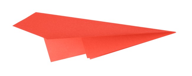 Photo of One handmade coral paper plane isolated on white