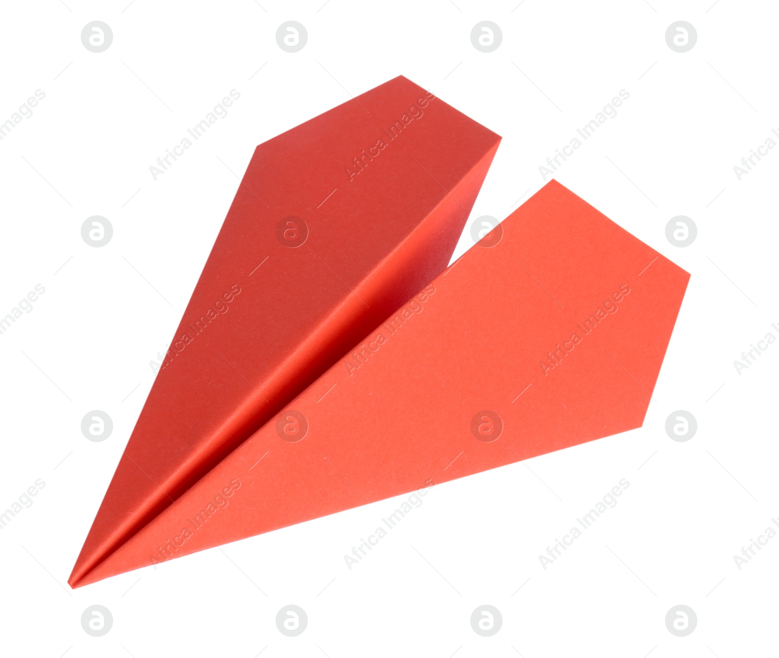 Photo of One handmade coral paper plane isolated on white