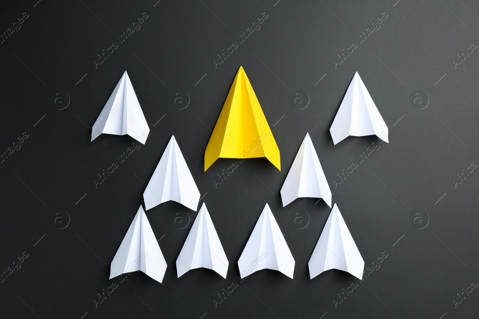 Photo of Paper planes on black background, top view