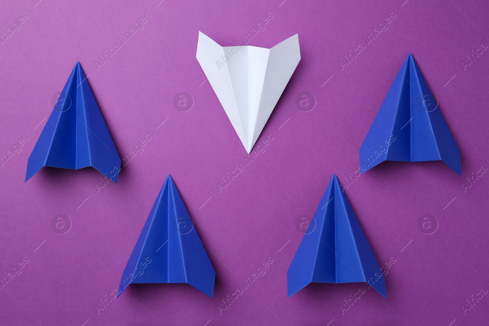 Photo of Paper planes on purple background, top view