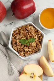 Photo of Tasty apple crisp in bowl, fresh fruits, honey and spoon on white marble table, flat lay