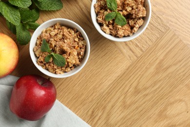 Photo of Delicious apple crisp, fresh fruits and mint on wooden table, flat lay. Space for text