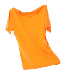 Photo of One orange t-shirt in air isolated on white