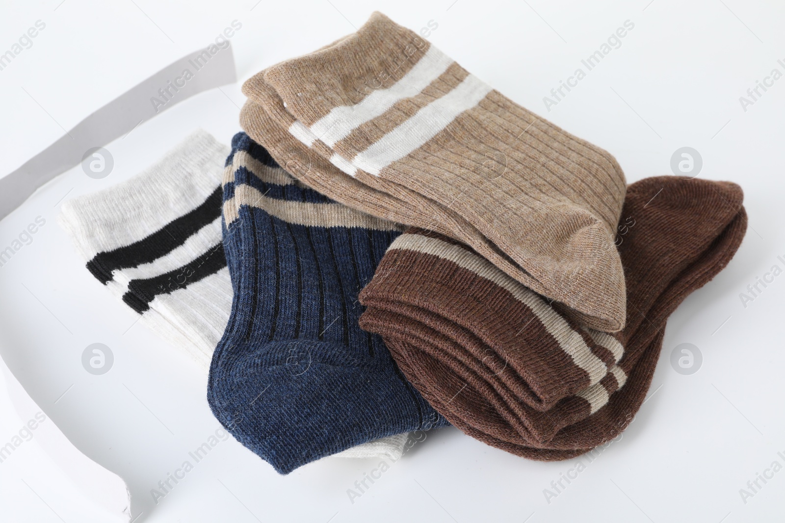 Photo of Pairs of soft socks isolated on white