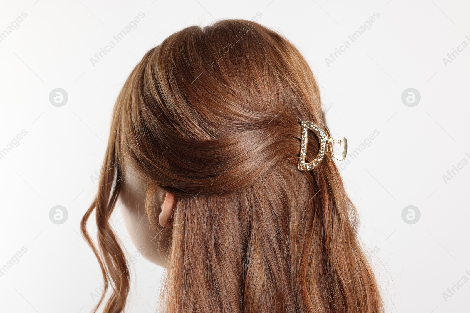 Photo of Teenage girl with stylish hair clip on white background, back view