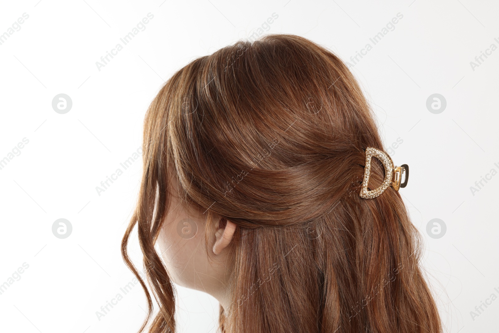 Photo of Teenage girl with stylish hair clip on white background, back view