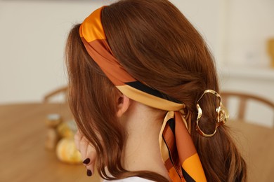 Teenage girl with stylish bandana indoors, back view