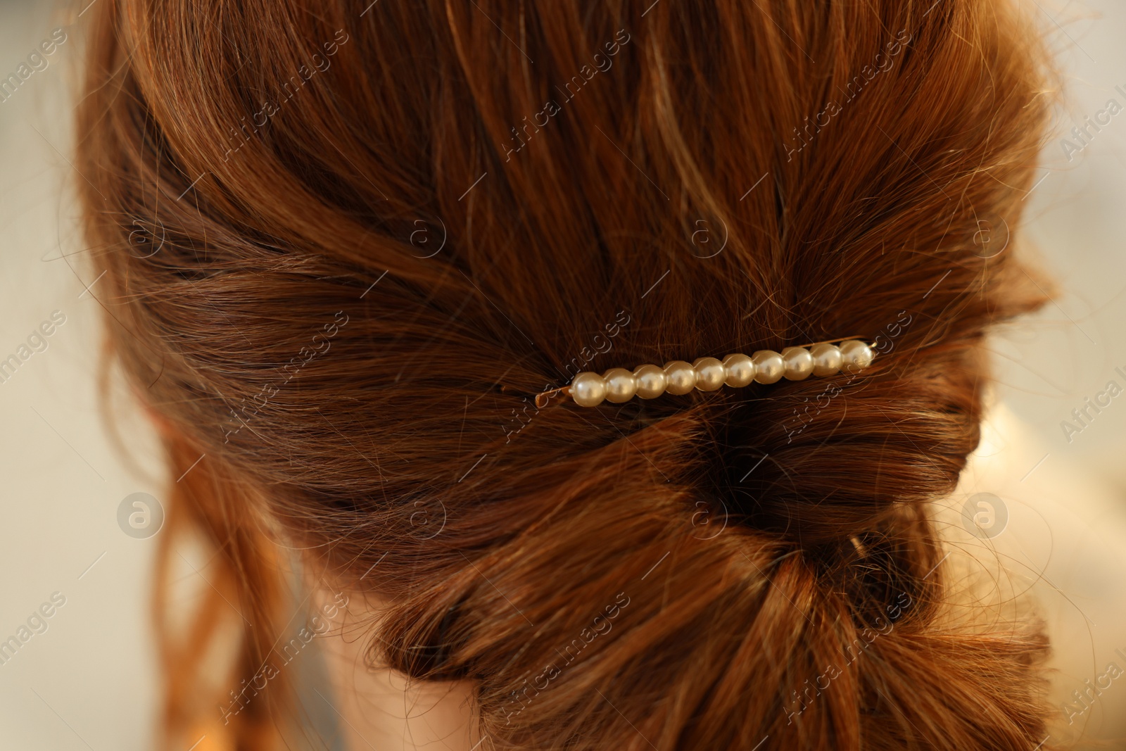 Photo of Teenage girl with stylish hair clip indoors, back view