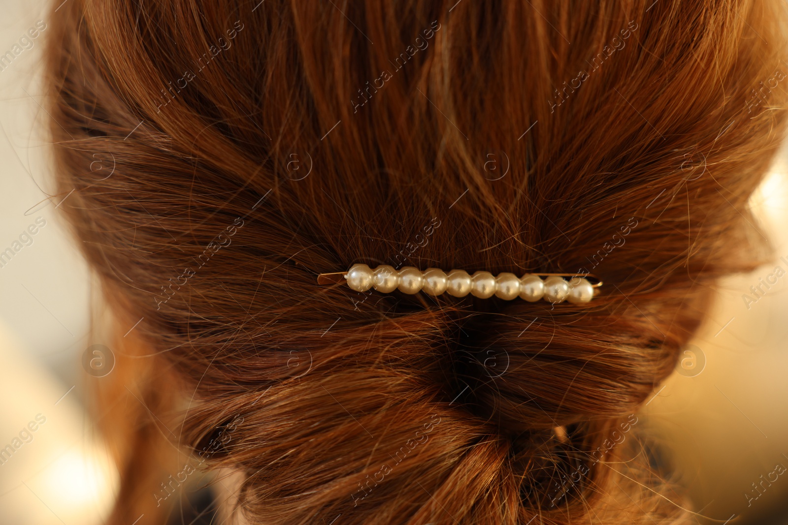 Photo of Teenage girl with stylish hair clip indoors, back view