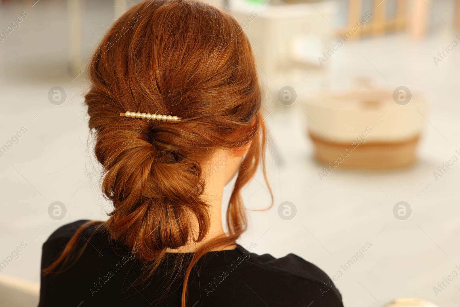 Photo of Teenage girl with stylish hair clip indoors, back view. Space for text