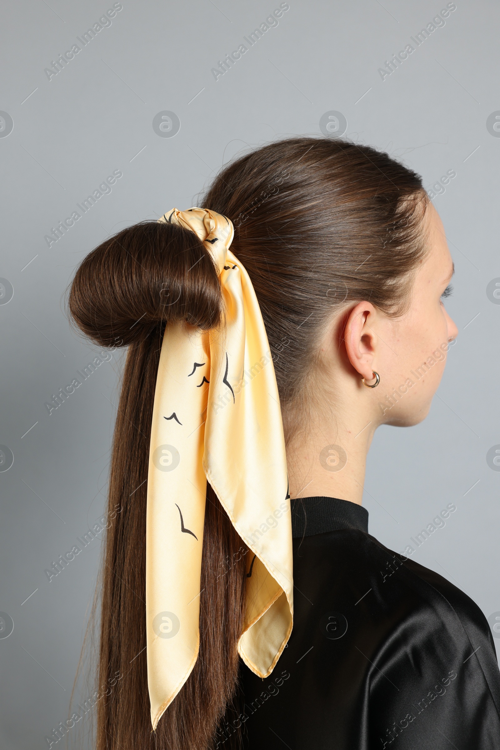 Photo of Teenage girl with stylish bandana on light grey background