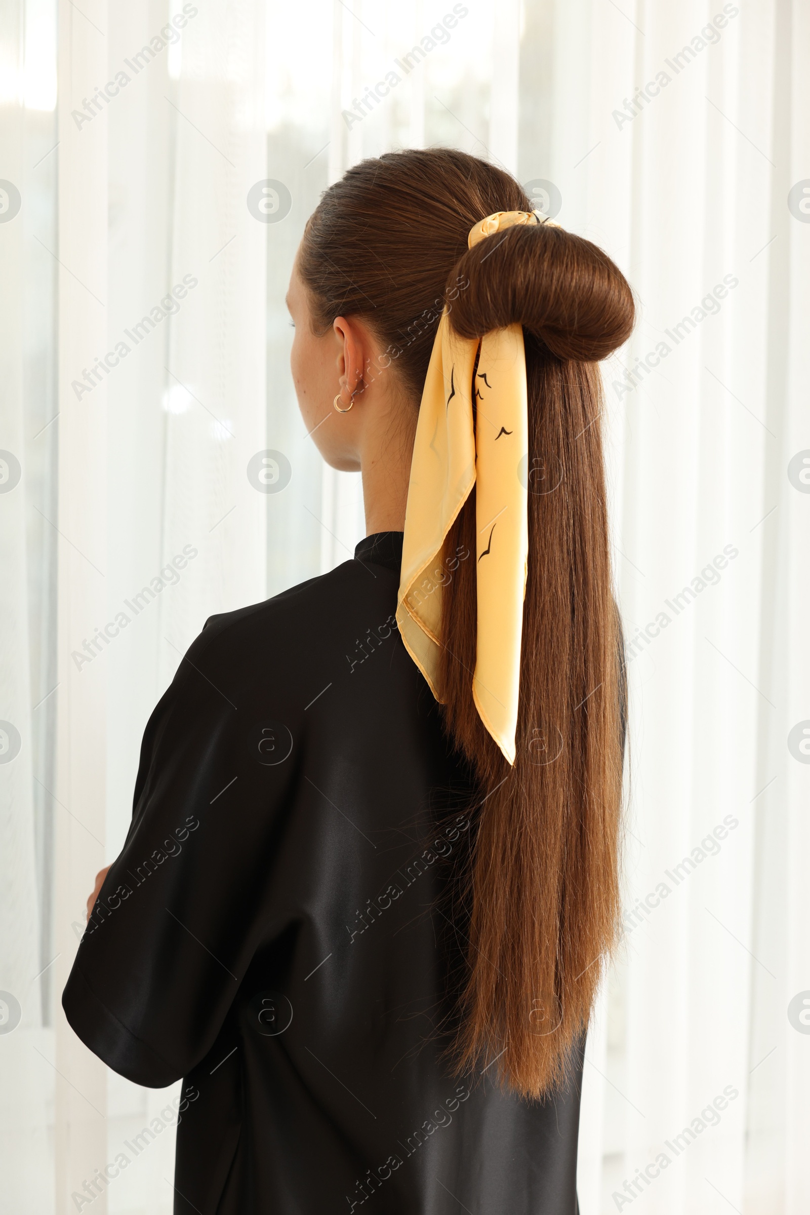 Photo of Teenage girl with stylish bandana indoors, back view