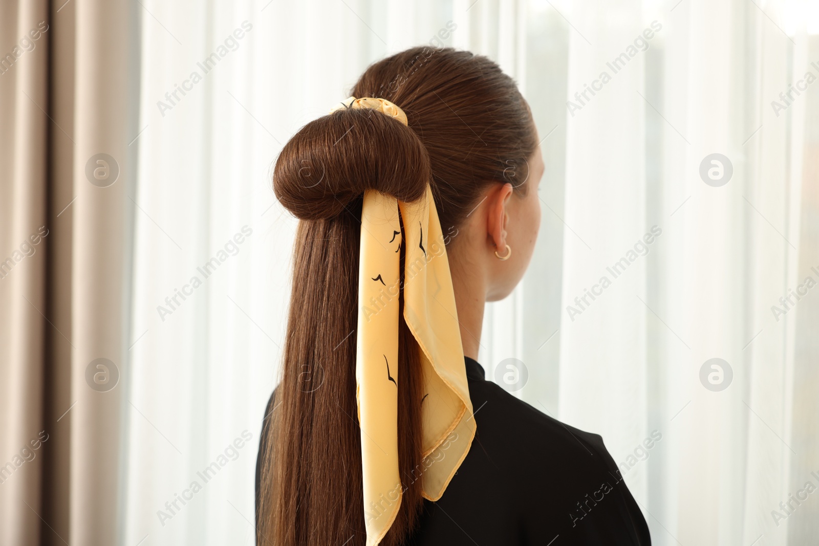 Photo of Teenage girl with stylish bandana indoors, back view