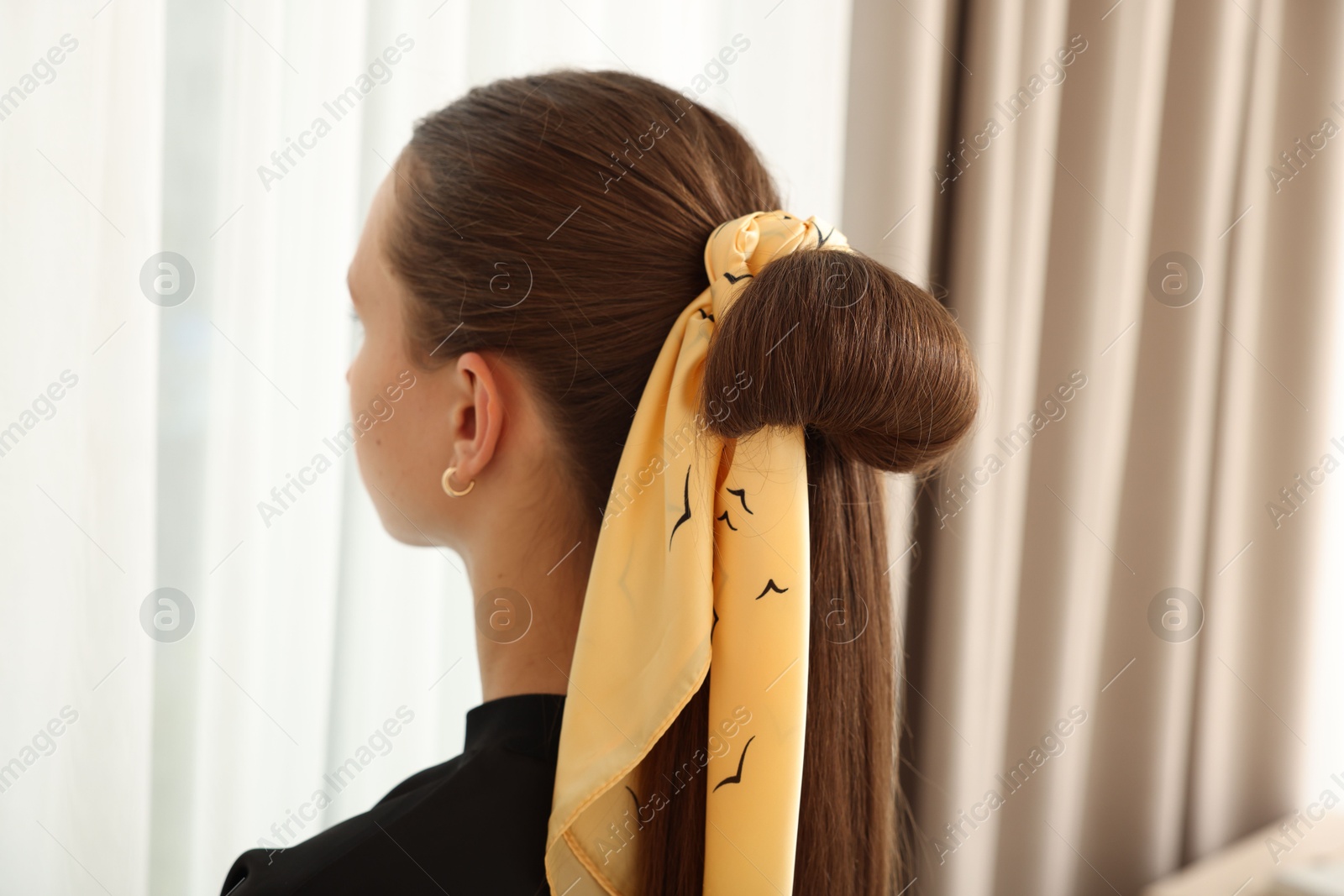 Photo of Teenage girl with stylish bandana indoors, back view