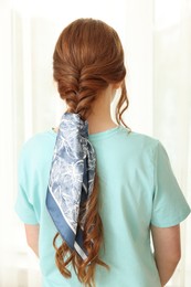 Teenage girl with stylish bandana indoors, back view